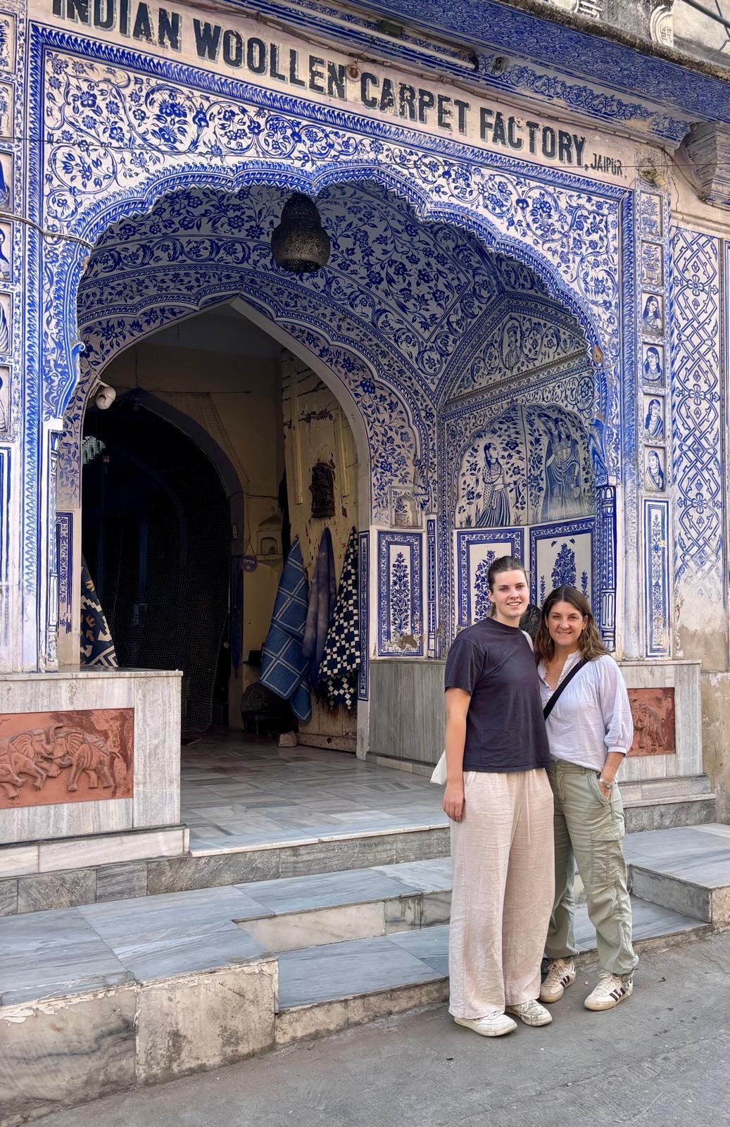 Guests visiting Jaipur's traditional blue pottery and carpet market with CJ by Ravi